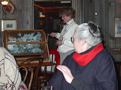 Norma gives the tickets a spin as Leslie observes, at Barnsider Dutch Treat Dinner 11/20/2001 V0010056