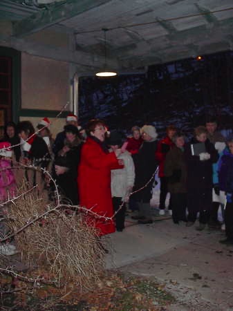 Susan, center, leading the caroling. December 8, 2002.IM003862.JPG