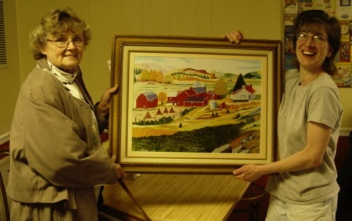 Norma presents Tom La Barbera's "Mary Cameron farm" raffle prize to Connie at 19 Main Street - 11/19/2003 DSC00487.