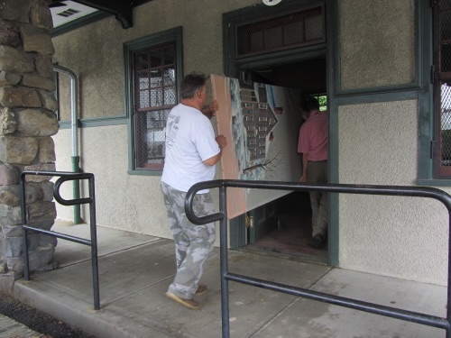 Rob and Clif carry the right panel into the 1915 Erie Station. (Leslie Smith photo)  2015-07-14 IMG_6528.jpg