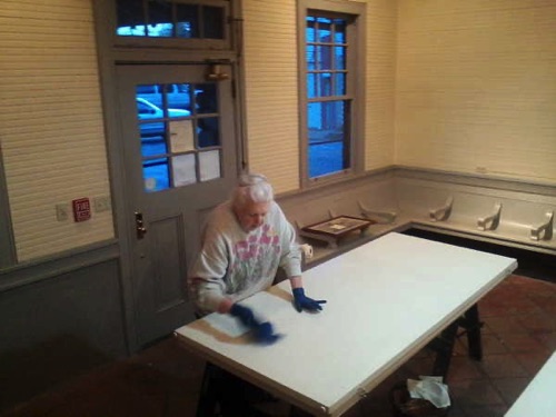 Leslie cleaning panels for "What We've Lost" exhibit." 04-17-2019